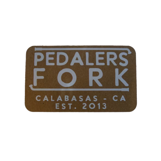 Brown colored sticker with text "Pedalers Fork Calabasas-CA EST. 2013"