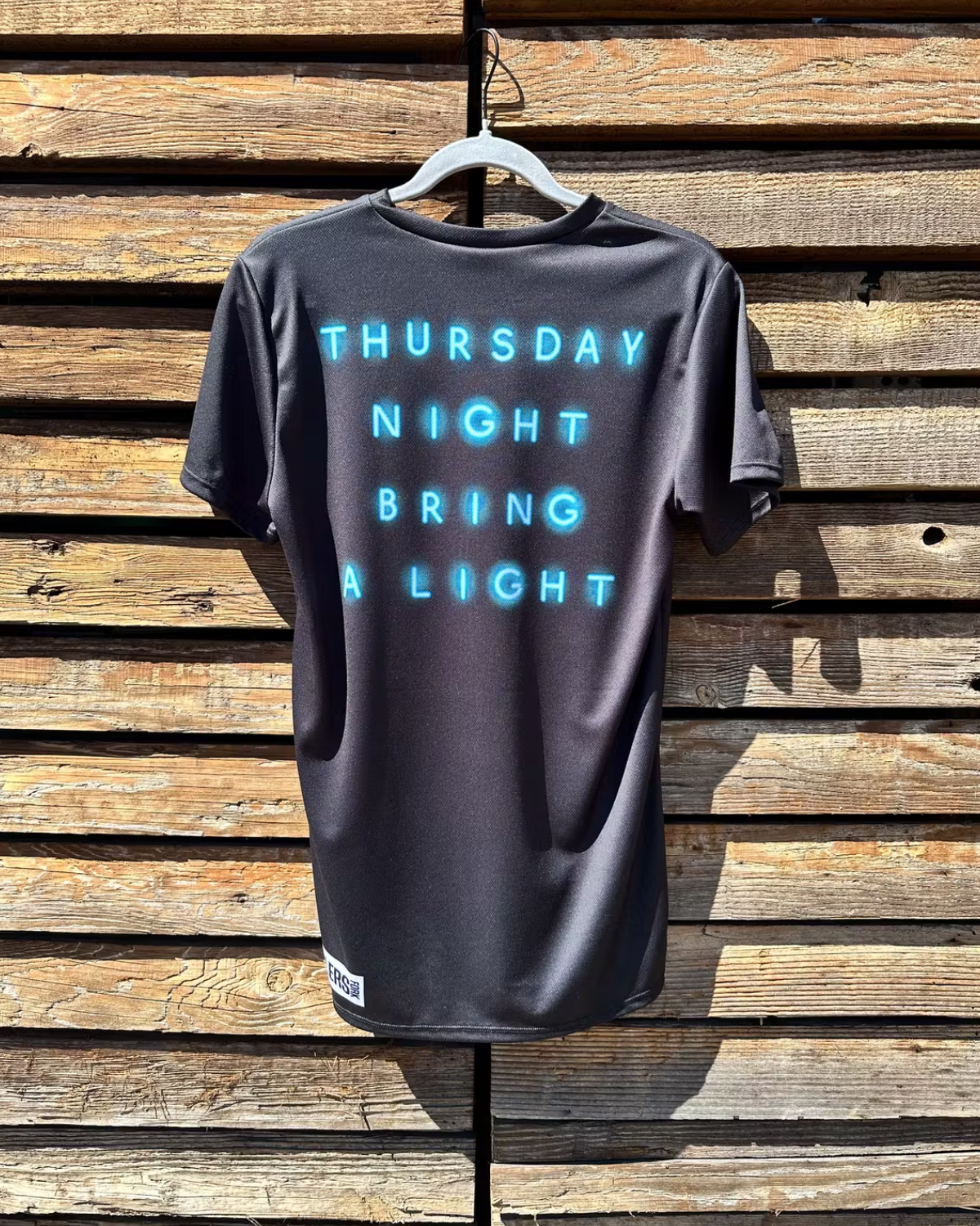 Back of Ride and Pint shirt with text "Thursday Night Bring a Light"